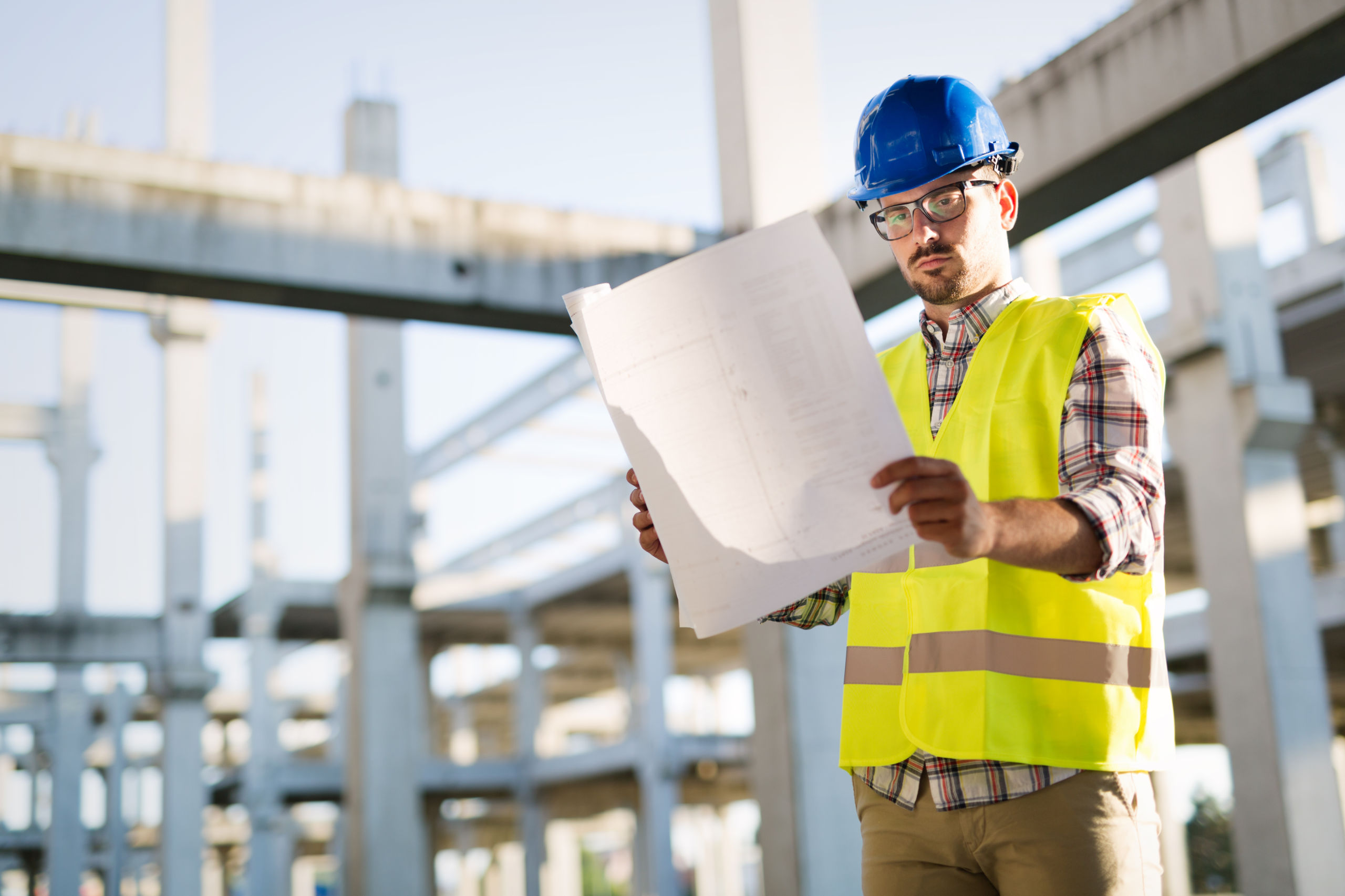 picture of construction site engineer looking at plan